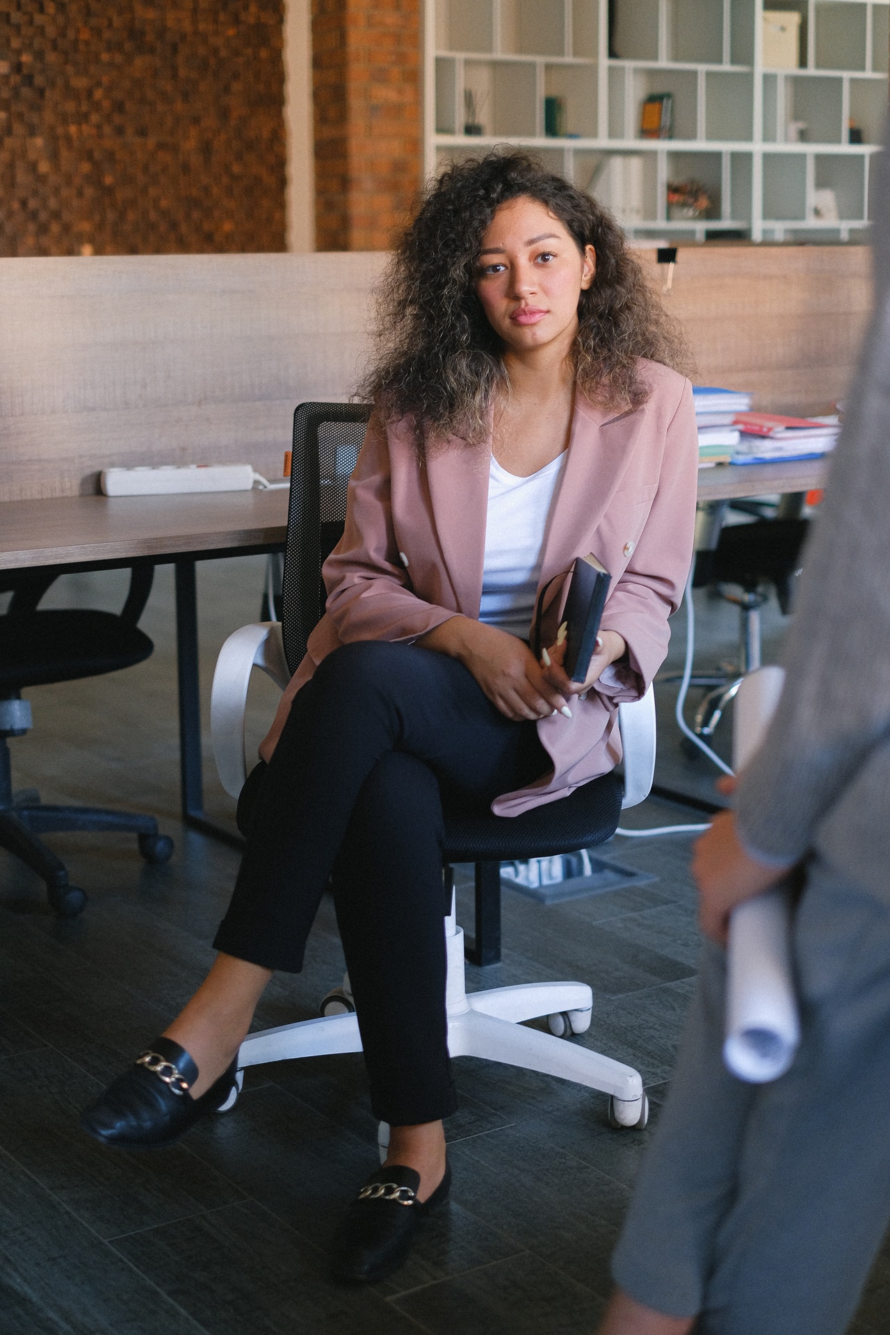 BIPOC Woman in a suit staring at the camera